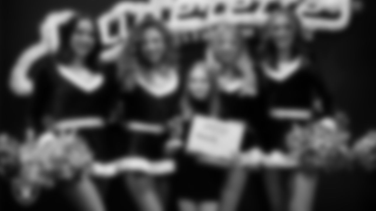 Raiderettes pose for a photo with a Junior Raiderette during the Junior Raiderettes Banquet at The Studio.