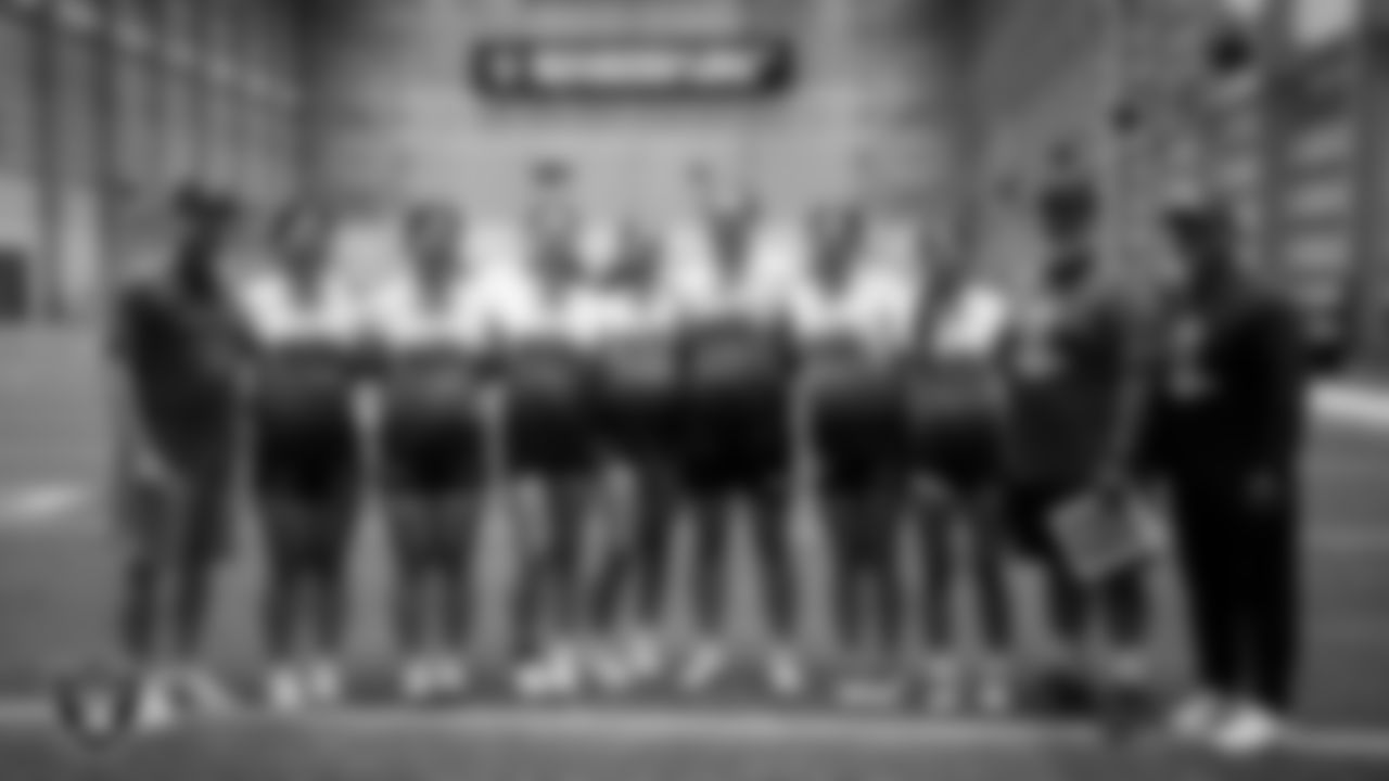 Athletes and coaches pose for a photo after practice at Intermountain Health Performance Center.