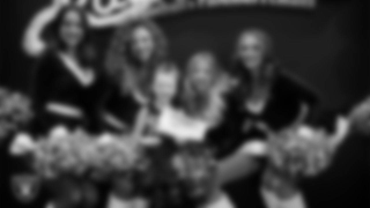 Raiderettes pose for a photo with a Junior Raiderette during the Junior Raiderettes Banquet at The Studio.