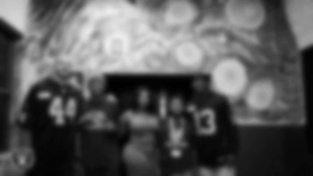Las Vegas Raiders linebacker Tommy Eichenberg (44) and wide receiver Phillip Dorsett II (13) pose for a photo with members of the Boys and Girls Club and their family at the Lied Memorial Boys & Girls Clubs of Southern Nevada.