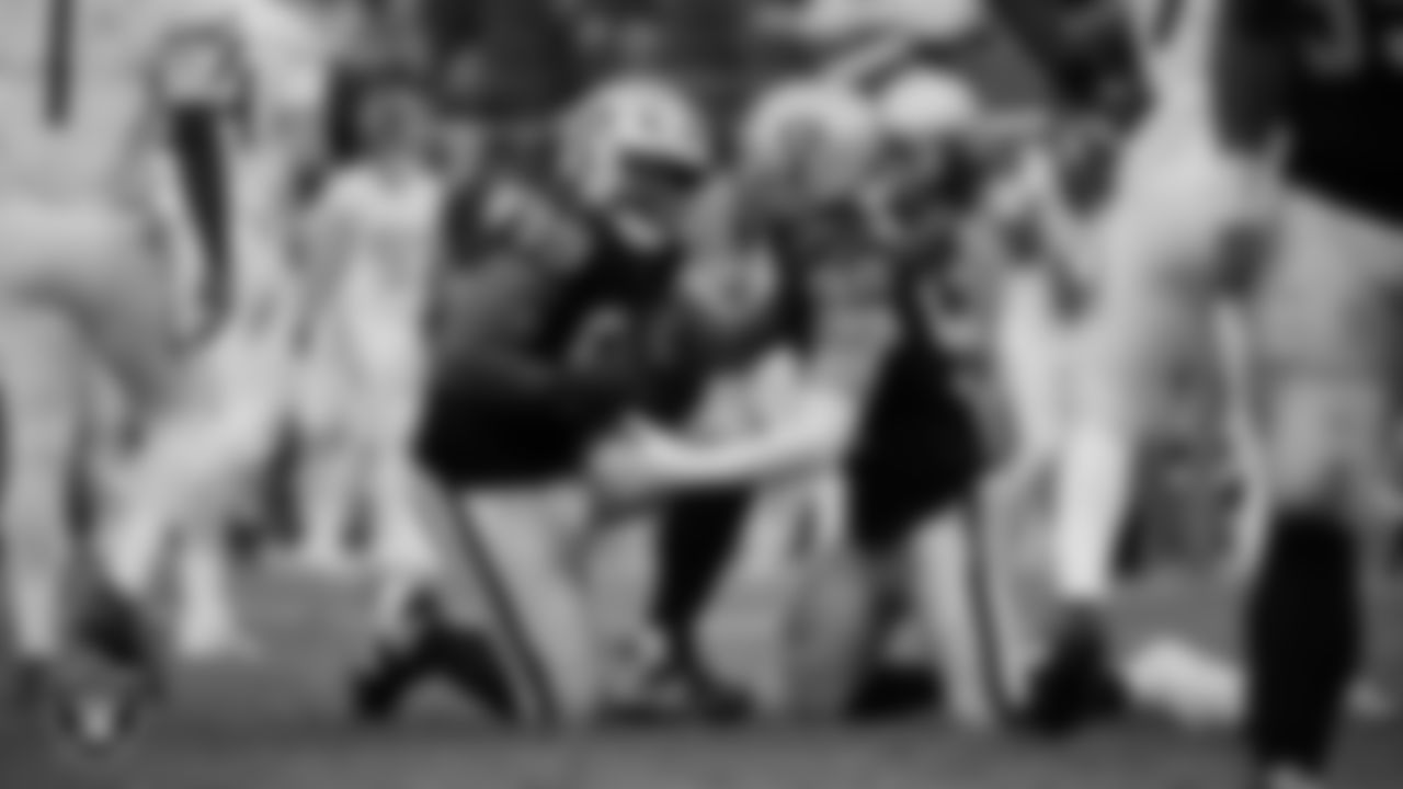 Las Vegas Raiders defensive tackle Thomas Booker IV (99) celebrates with defensive end Maxx Crosby (98) after recovering a fumble during the regular season home game against the Tennessee Titans at Allegiant Stadium.