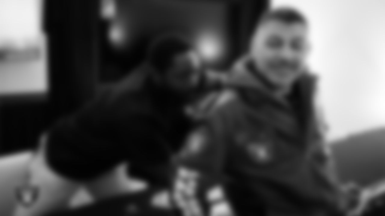 Las Vegas Raiders alumnus Cory Littleton signs an autograph for a service member at Nellis Air Force Base.