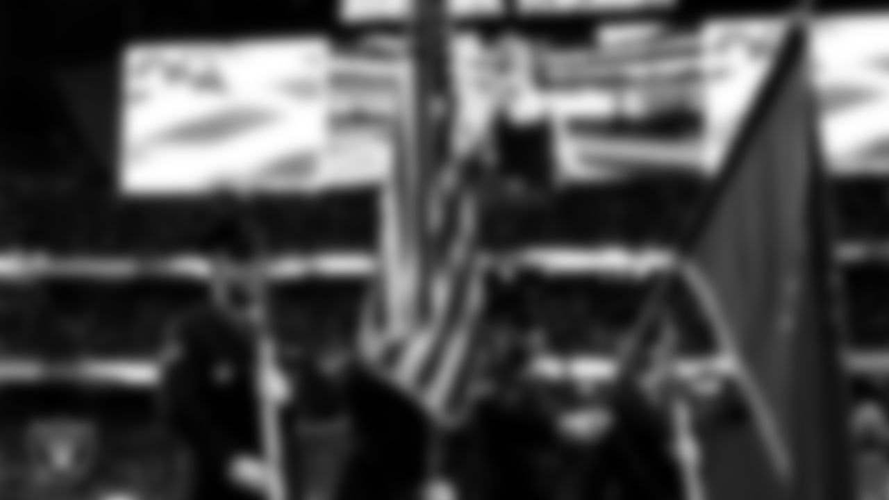 The Honor Guard from Creech Air Force Base presents the nation's colors during the national anthem before the Las Vegas Raiders' regular season home game against the Los Angeles Chargers at Allegiant Stadium.