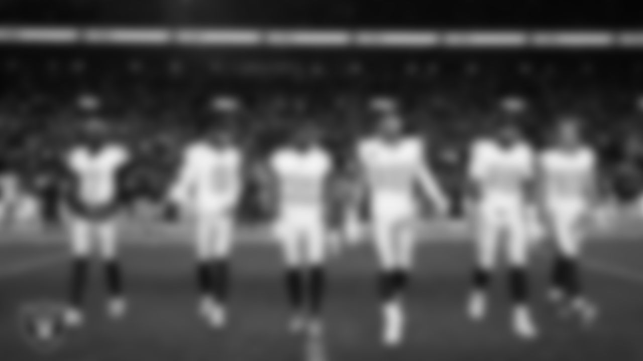 The Las Vegas Raiders walk out to the center of the field for the coin toss before the regular season away game against the the Denver Broncos at Empower Field at Mile High.