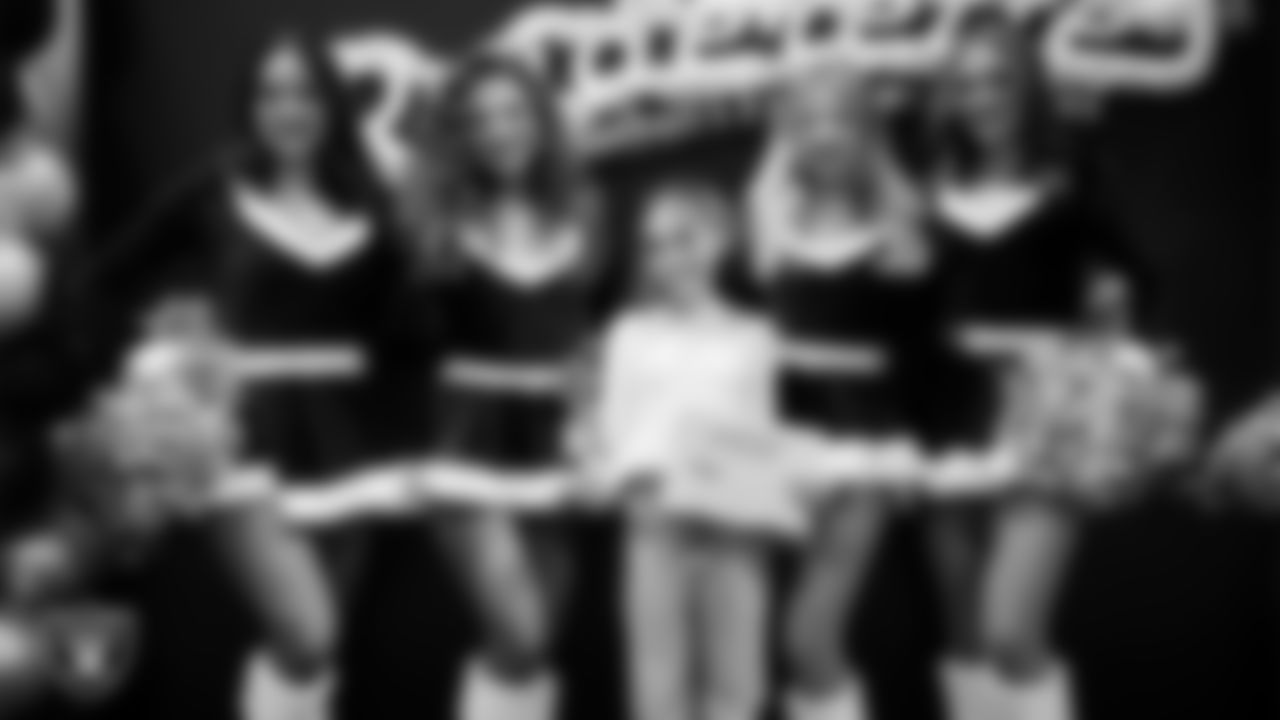 Raiderettes pose for a photo with a Junior Raiderette during the Junior Raiderettes Banquet at The Studio.