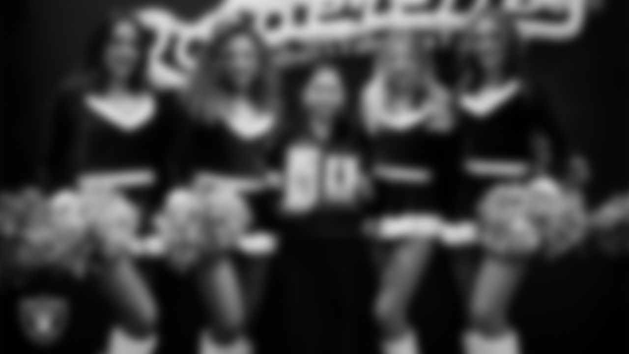 Raiderettes pose for a photo with a Junior Raiderette during the Junior Raiderettes Banquet at The Studio.