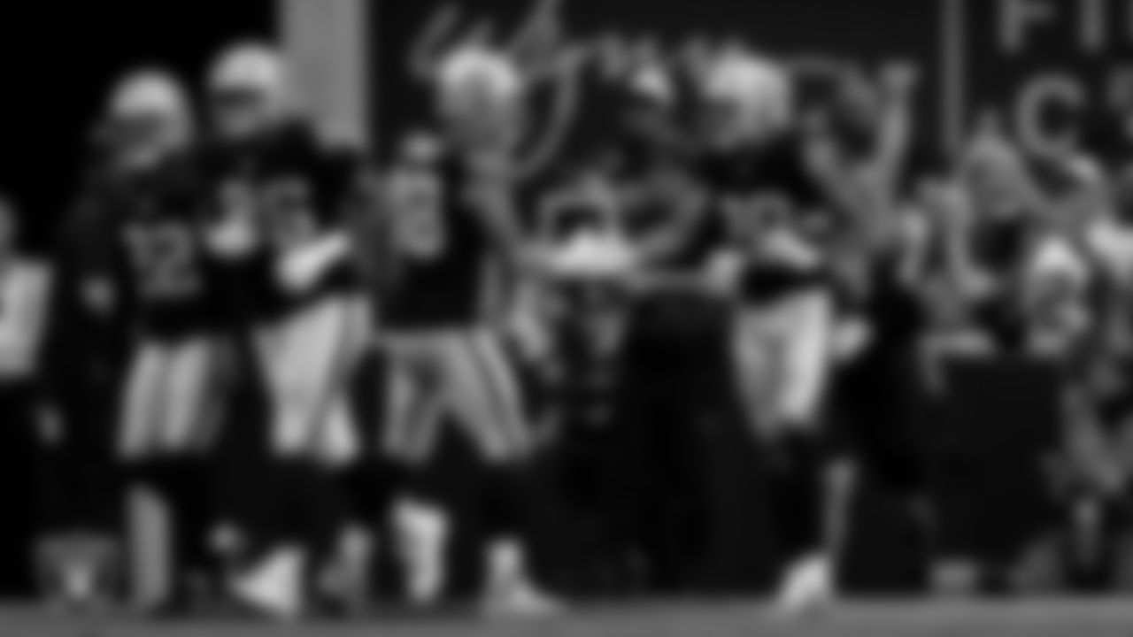 Las Vegas Raiders safety Isaiah Pola-Mao (20) celebrates with defensive end Maxx Crosby (98) after intercepting a pass during the regular season home game against the Jacksonville Jaguars at Allegiant Stadium.