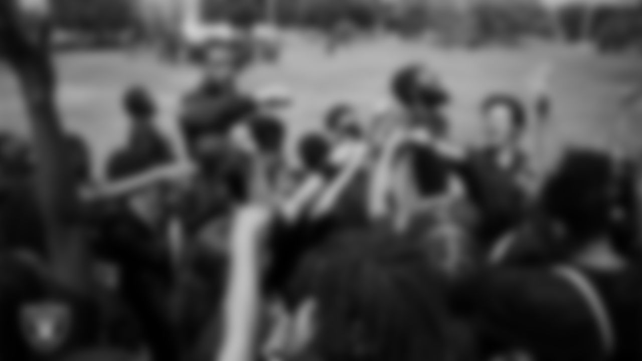 Las Vegas Raiders safety Jeremy Chinn (11) huddles with students during a Raiders Junior Training Camp at Matt Kelly Elementary School.