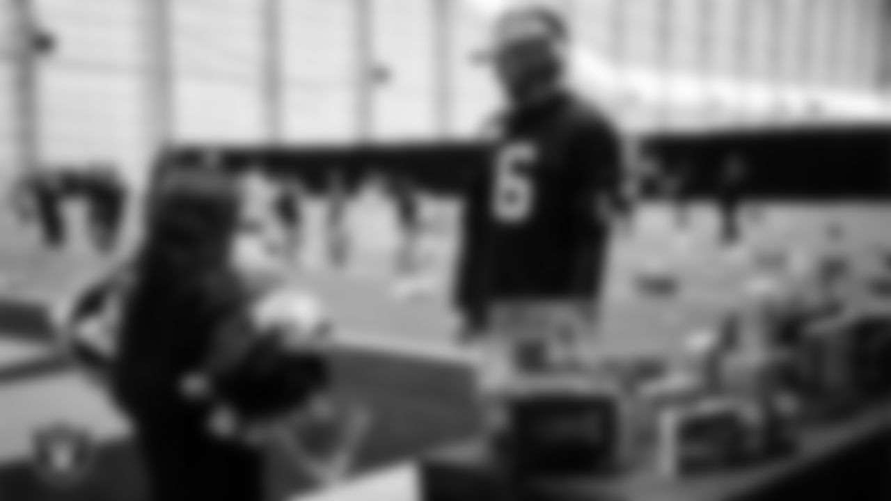 Las Vegas Raiders punter AJ Cole (6) helps a student select toys during a Raiders Youth Holiday Party at Intermountain Health Performance Center.