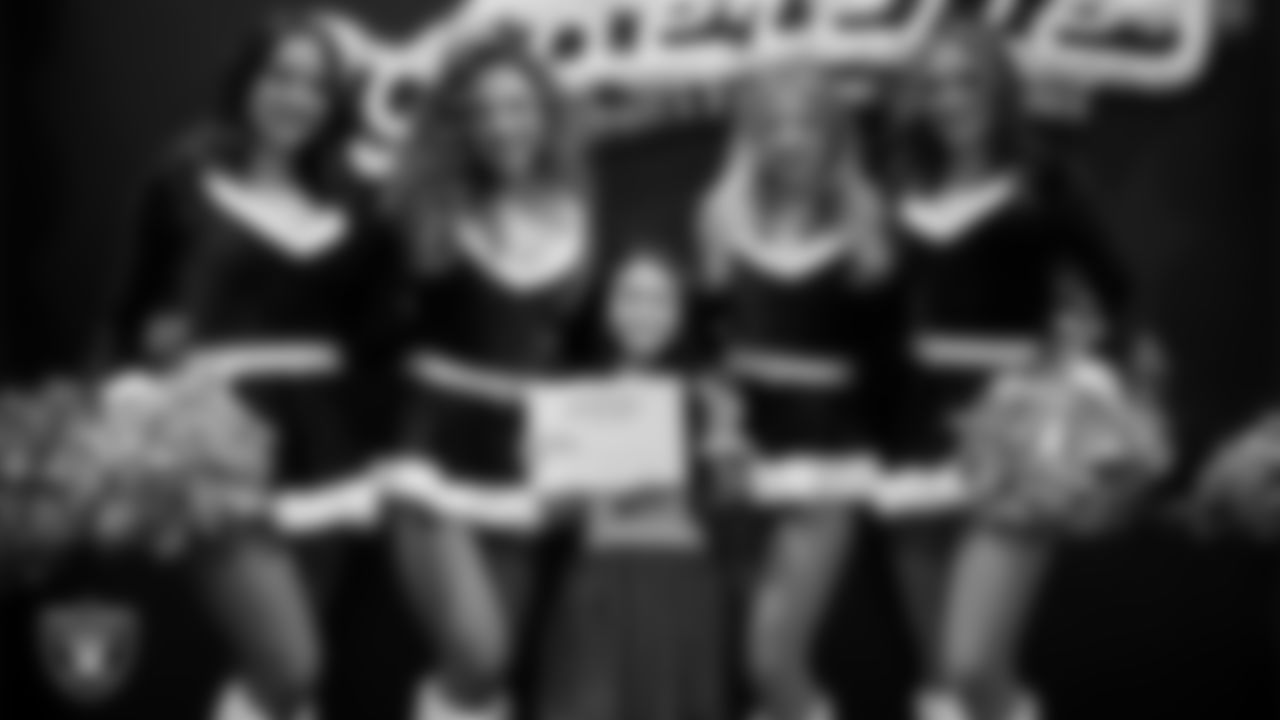 Raiderettes pose for a photo with a Junior Raiderette during the Junior Raiderettes Banquet at The Studio.