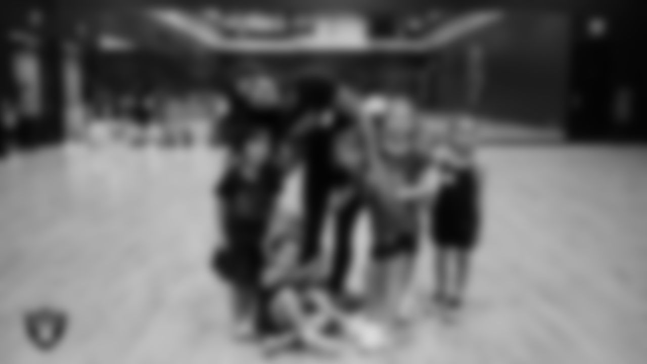 Raiderette Meekela poses for a photo with dancers during day one of summer camp at The Studio.