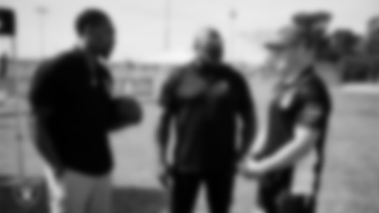 Las Vegas Raiders alumni Korey Toomer and Roy Hart talk with St. George Illawarra Dragons second-row forward Dylan Egan during the NRL Gala Day flag football tournament at Silver Bowl Park.