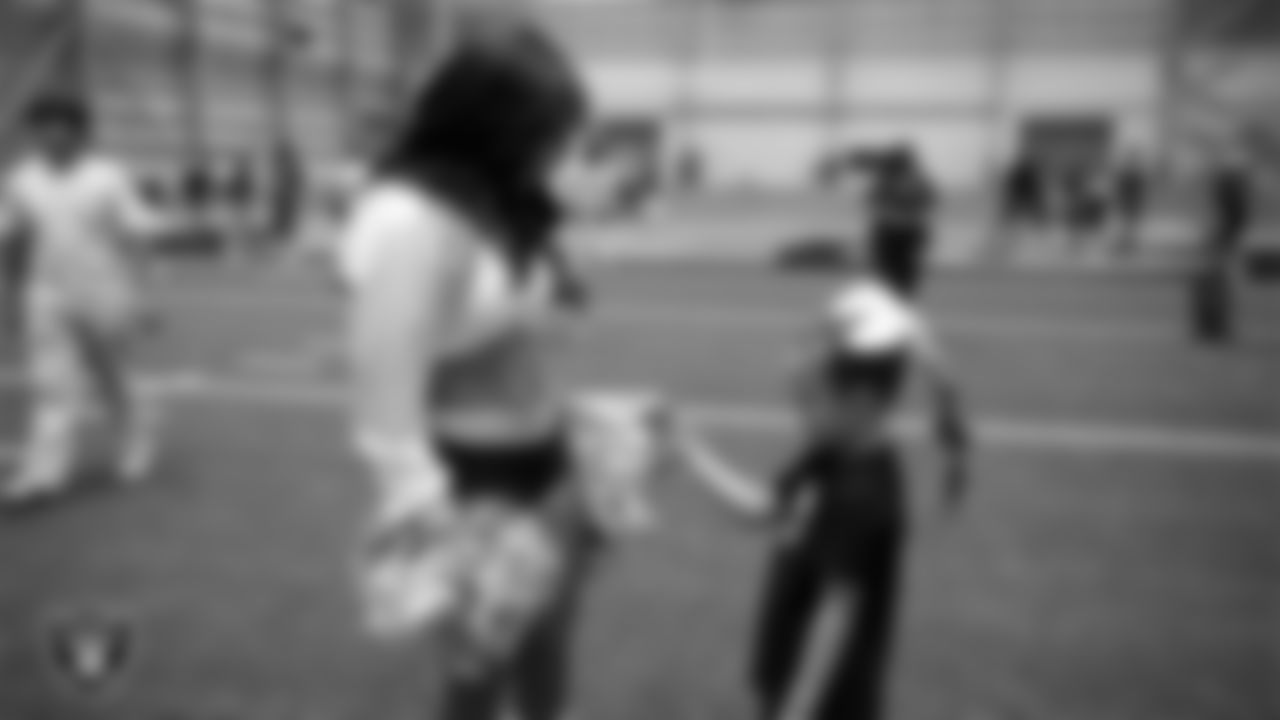 Raiderette Bria with a dancer during day three of summer camp at Intermountain Health Performance Center.