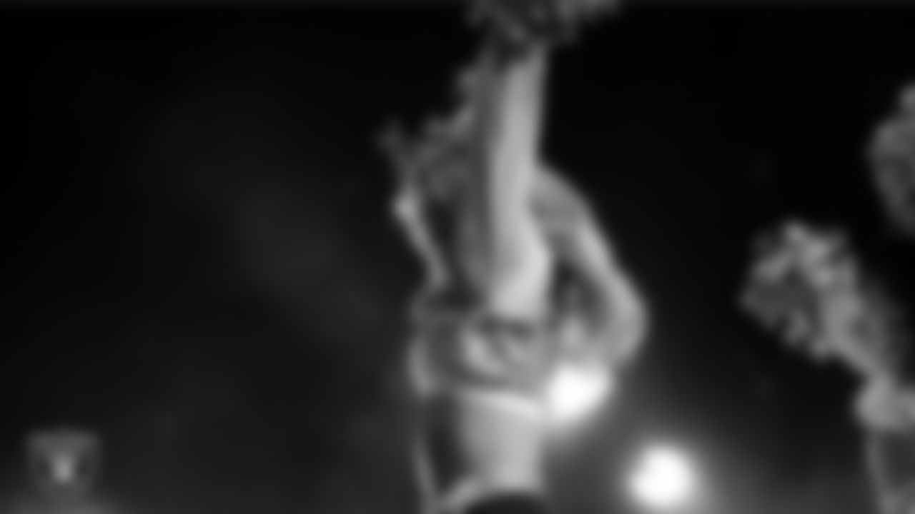 Raiderette Pip performs with Rapper Nelly at halftime during the regular season home game against the Dallas Cowboys at Allegiant Stadium.