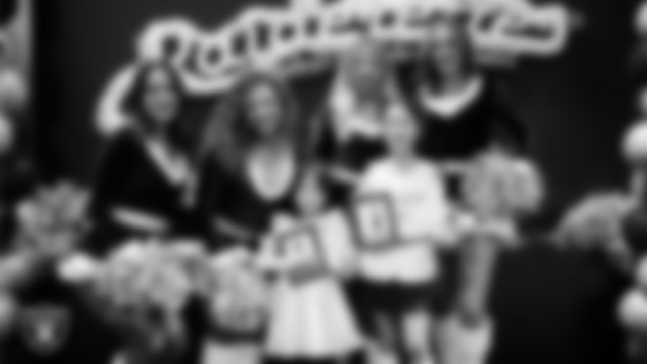 Raiderettes pose for a photo with Junior Raiderettes during the Junior Raiderettes Banquet at The Studio.