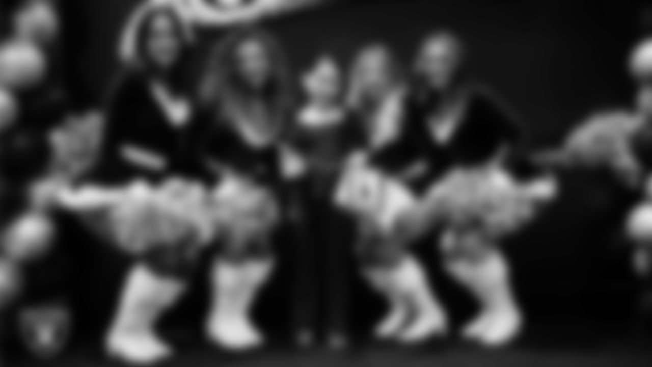 Raiderettes pose for a photo with a Junior Raiderette during the Junior Raiderettes Banquet at The Studio.