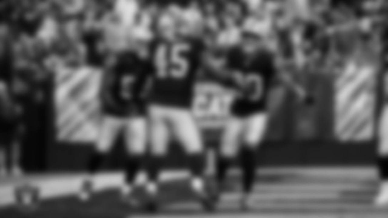 Las Vegas Raiders linebacker Devin White (45) celebrates with linebacker Elandon Roberts (52) and safety Isaiah Pola-Mao (20) after sacking the quarterback during the regular season home game against the Tennessee Titans at Allegiant Stadium.