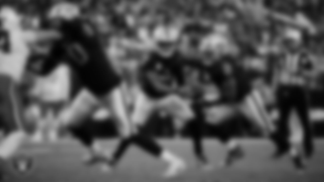 Las Vegas Raiders quarterback Geno Smith (7) hands the ball off to running back Ashton Jeanty (2) during the regular season home game against the Cleveland Browns at Allegiant Stadium.