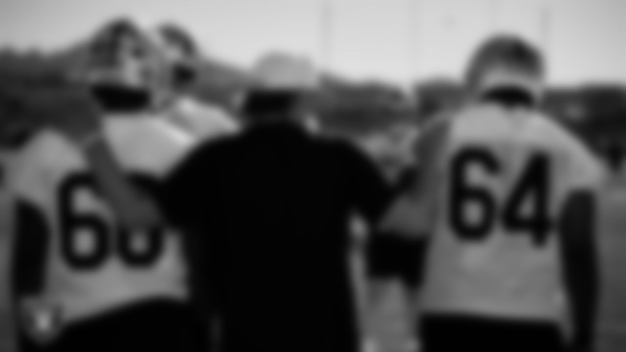 Las Vegas Raiders tackle Charles Grant (60), run game coordinator/offensive line coach Brennan Carroll and guard Layden Robinson (64) during practice at Intermountain Health Performance Center.