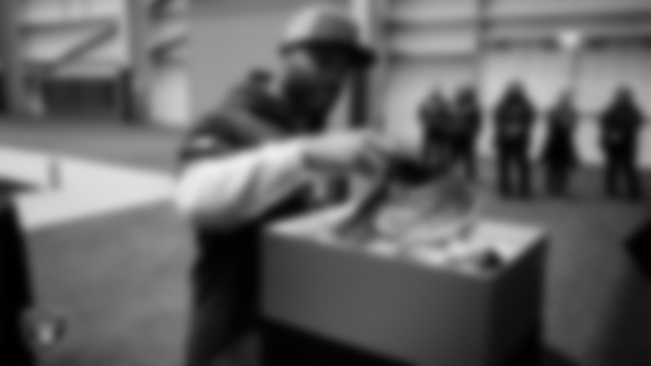 Las Vegas Raiders linebacker Elandon Roberts (52) unboxes his custom cleats for the NFL's My Cause My Cleats initiative at Intermountain Health Performance Center.