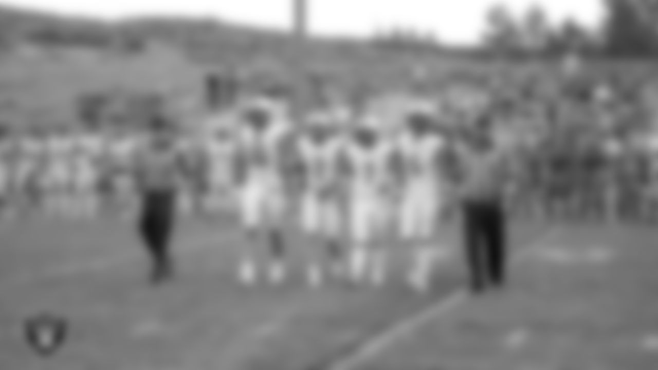 Churchill County High School football team members walk out to the center of the field for the coin toss before the Las Vegas Raiders' Football Showcase game between North Valleys High School and Churchill County High School at North Valleys High School.