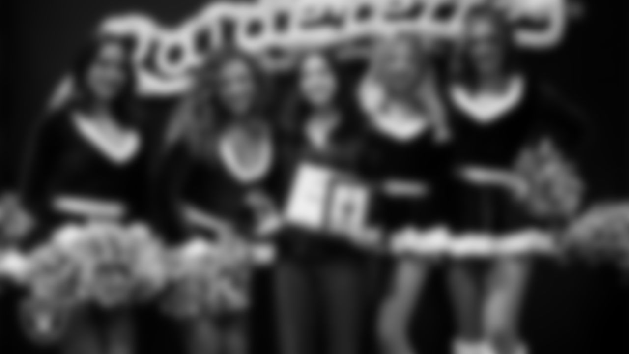 Raiderettes pose for a photo with a Junior Raiderette during the Junior Raiderettes Banquet at The Studio.