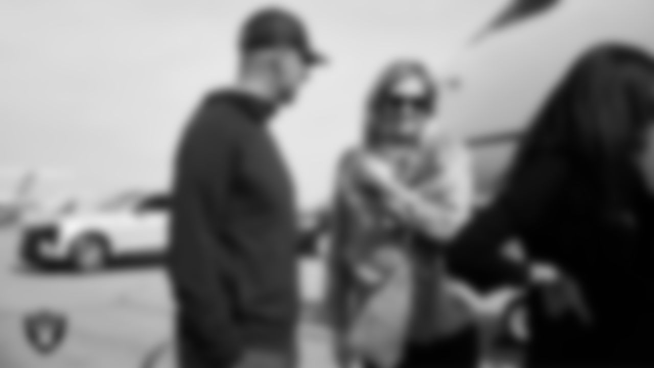 Las Vegas Raiders General Manager John Spytek greets Head Coach Klint Kubiak's wife Tessa Kubiak as she and her family arrive in Henderson.