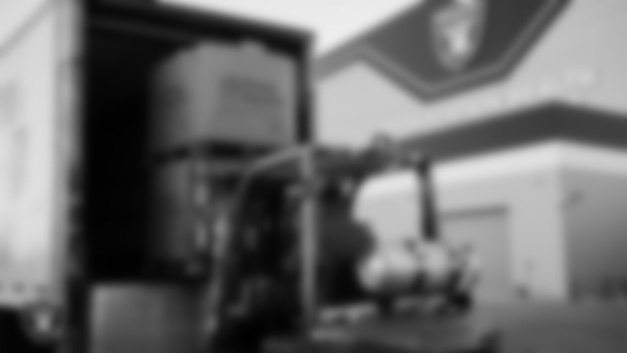 Meals are loaded onto a truck during the Raiders Holiday Meal Packing Party at Intermountain Health Performance Center.