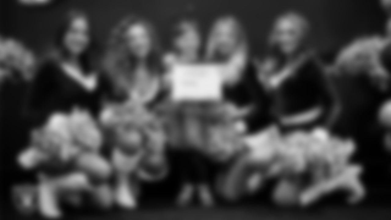 Raiderettes pose for a photo with a Junior Raiderette during the Junior Raiderettes Banquet at The Studio.