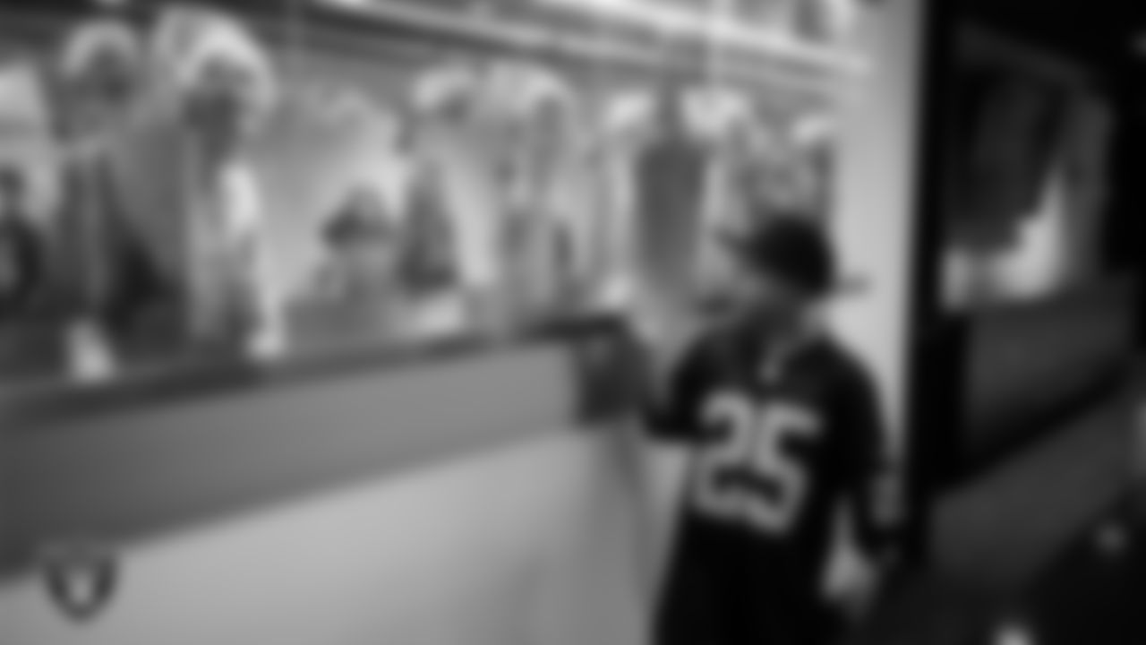 Christopher Arias from Make-A-Wish looks over the Las Vegas Raiders' Super Bowl trophies during a visit to Intermountain Health Performance Center.