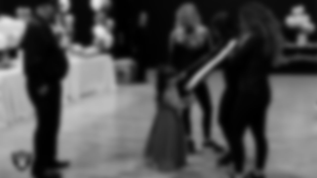 Raiderettes Delaney, Ashtin and Lexie welcome an attendee to the Valentine's Day Dance at The Studio.