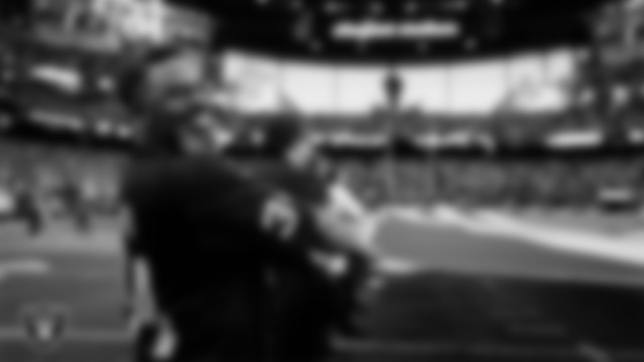 The American flag is displayed by Personal Seat License (PSL) holders on the field during the national anthem before the Las Vegas Raiders' regular season home game against the Denver Broncos at Allegiant Stadium.
