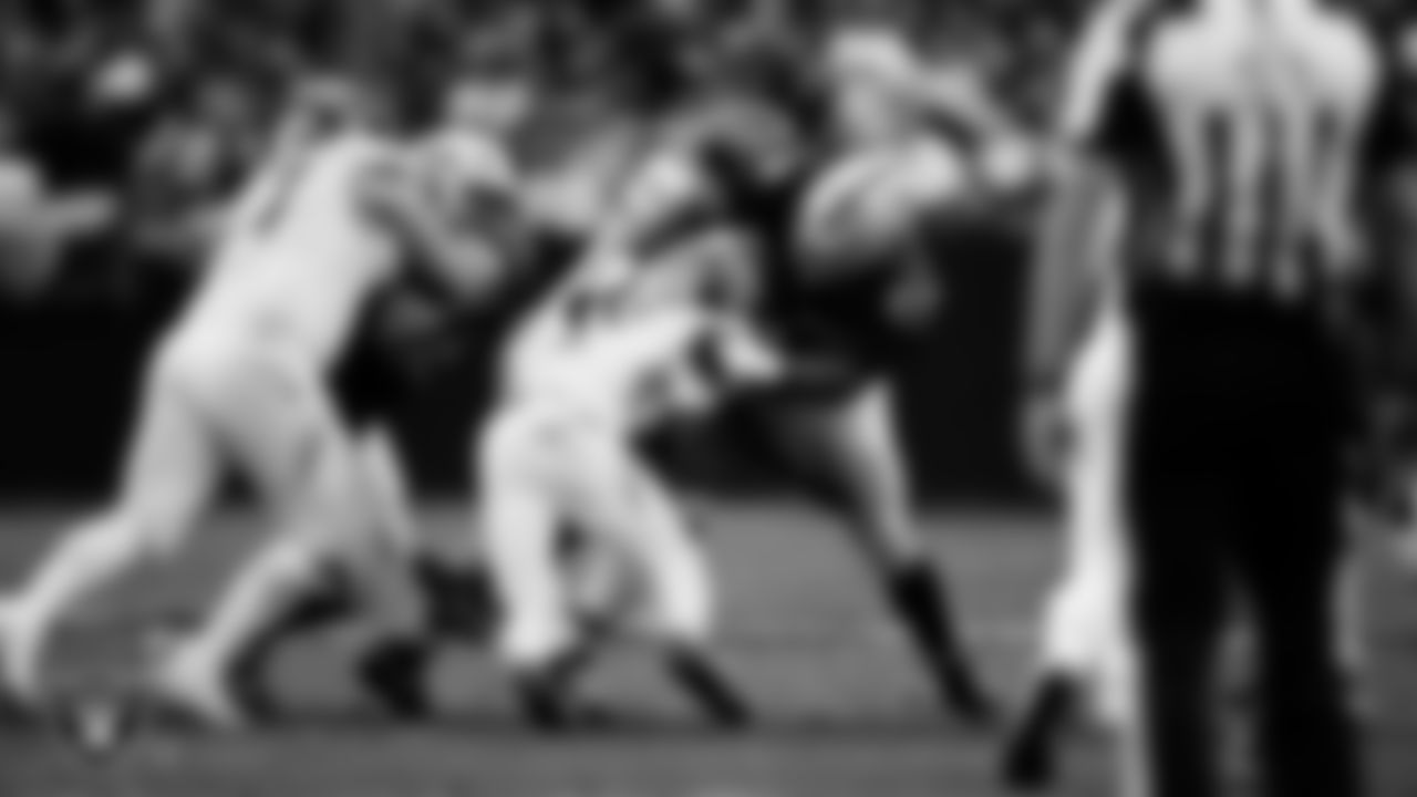 Las Vegas Raiders defensive tackle Thomas Booker IV (99) and defensive tackle Adam Butler (69) go to make a tackle during the regular season home game against the Tennessee Titans at Allegiant Stadium.