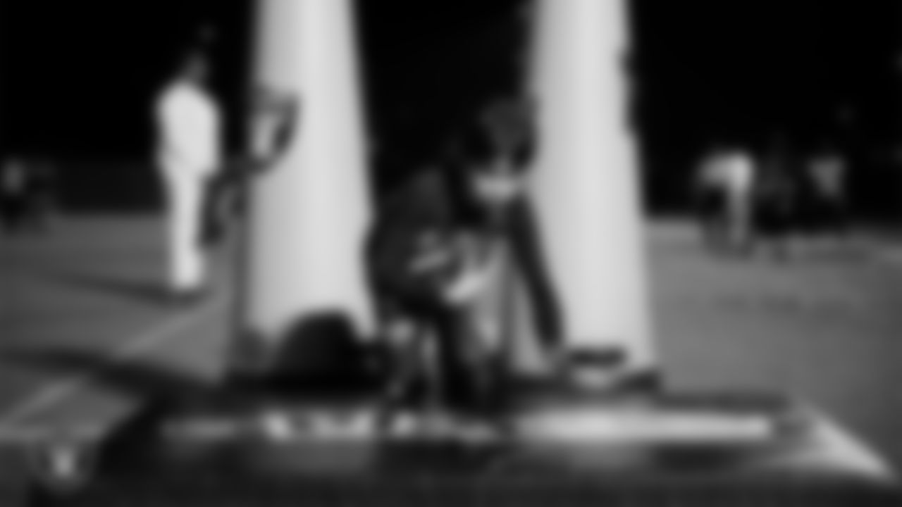 An athlete takes part in a Silver and Black League flag football clinic at Bill and Lillie Heinrich YMCA.