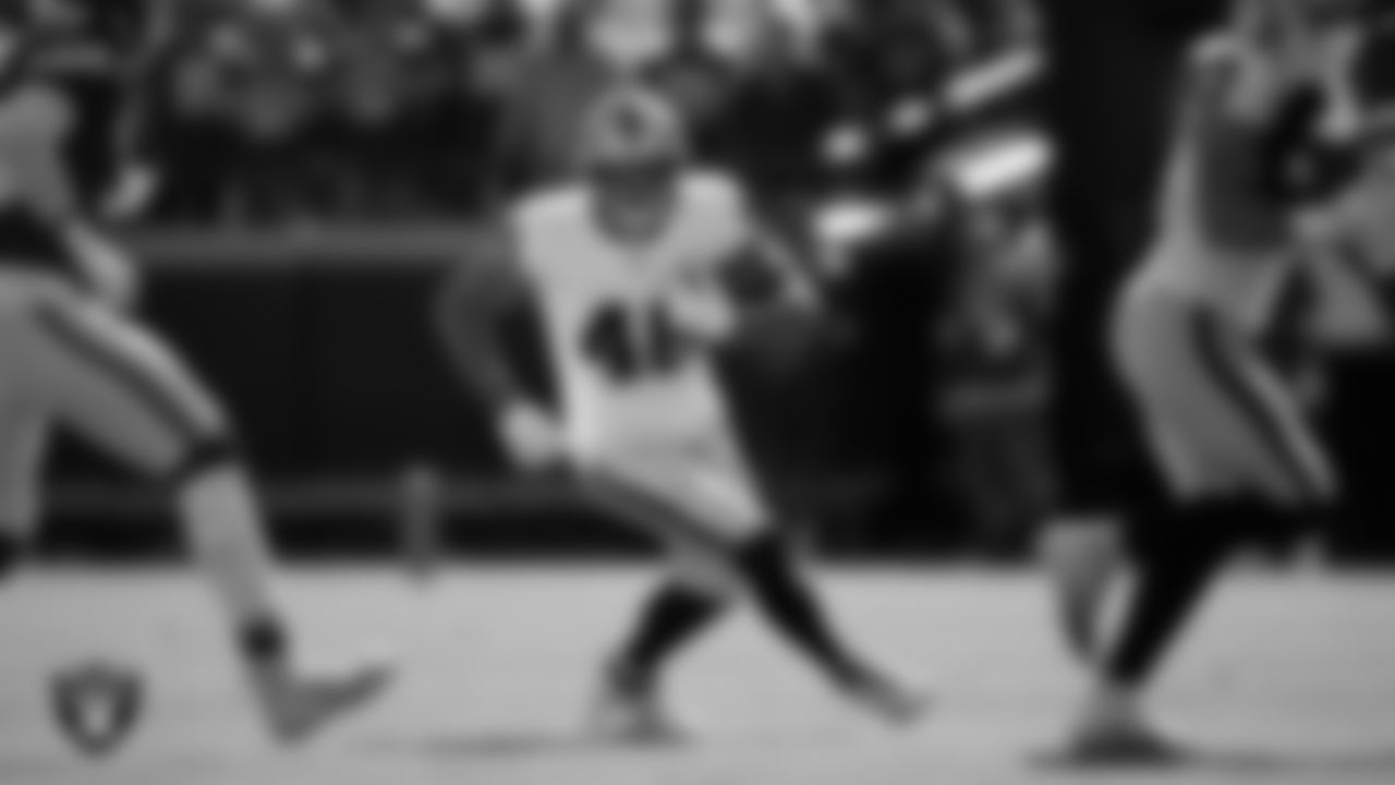Las Vegas Raiders tight end Carter Runyon (46) runs after making a catch during the regular season away game against the Kansas City Chiefs at GEHA Field at Arrowhead Stadium.