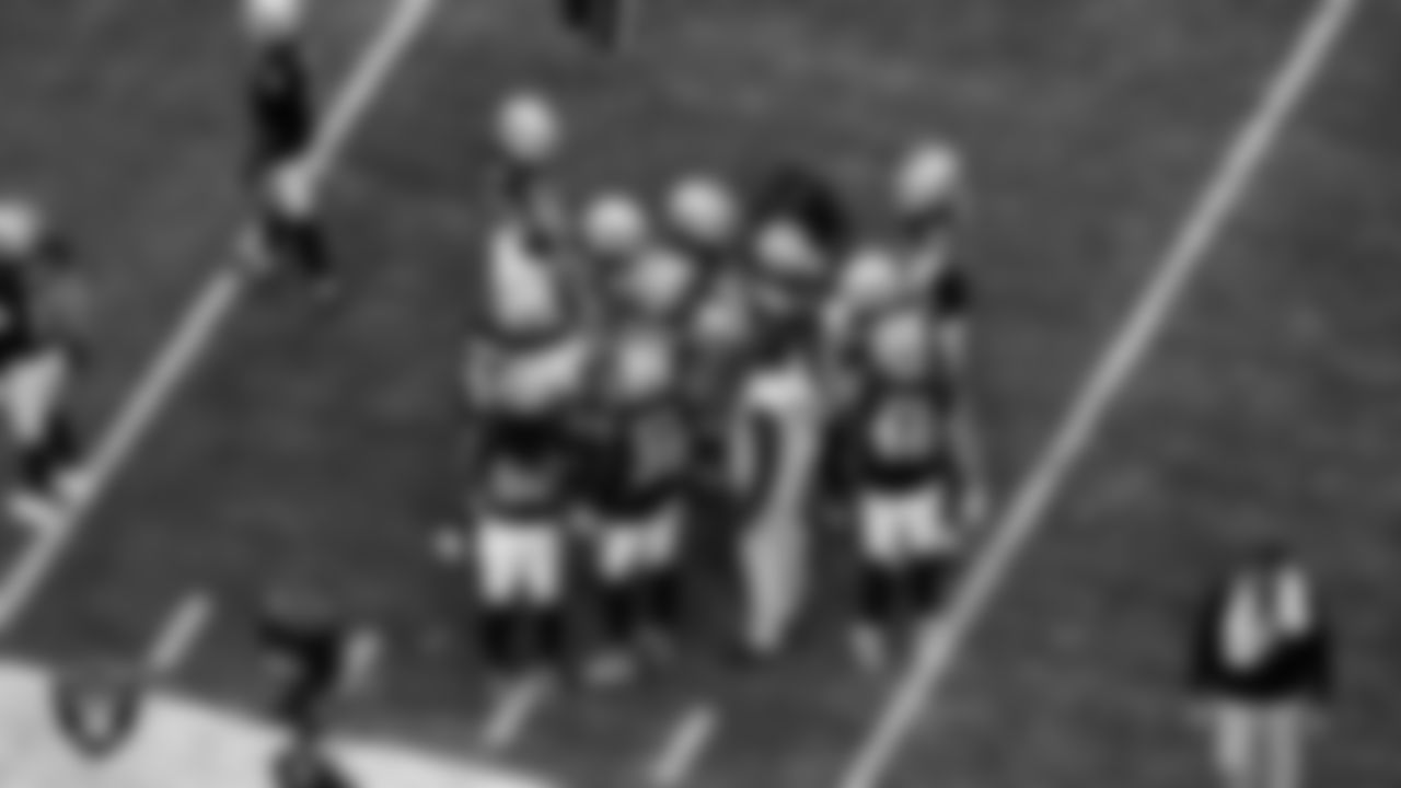 The Las Vegas Raiders huddle during the regular season home game against the Denver Broncos at Allegiant Stadium.