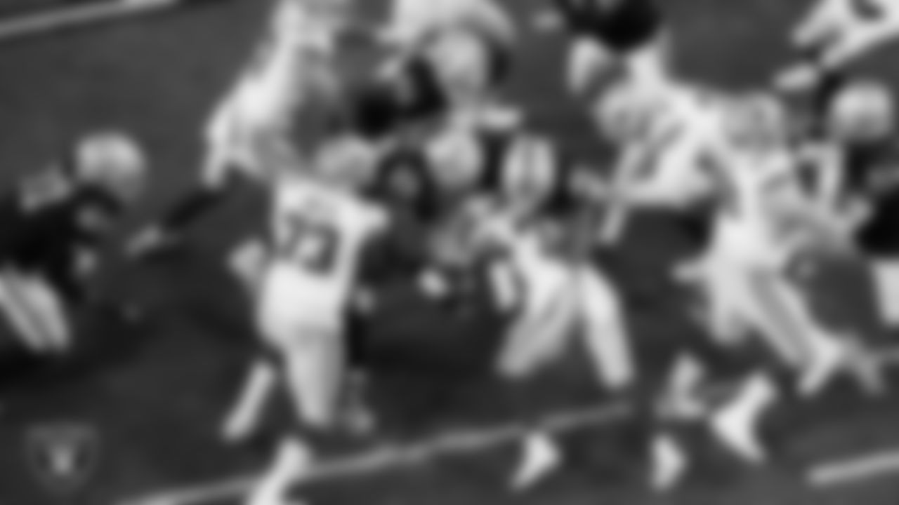 Las Vegas Raiders defensive tackle Adam Butler (69) and defensive tackle Jonah Laulu (96) make a tackle during the regular season home game against the Dallas Cowboys at Allegiant Stadium.