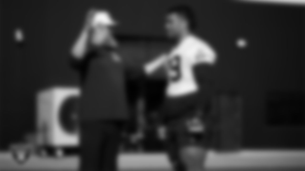 Las Vegas Raiders run game coordinator/offensive line coach Brennan Carroll and offensvie lineman Laki Tasi (79) during practice at Intermountain Health Performance Center.