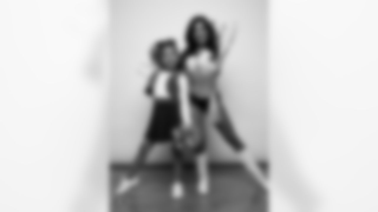 Raiderette Tatiana poses for a photo with a Junior Raiderette during 2025 Media Day at The Studio.