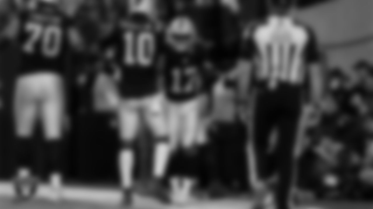 Las Vegas Raiders wide receiver Tyler Lockett (17) celebrates with teammates after making a 4-yard touchdown catch during the regular season home game against the New York Giants at Allegiant Stadium.
