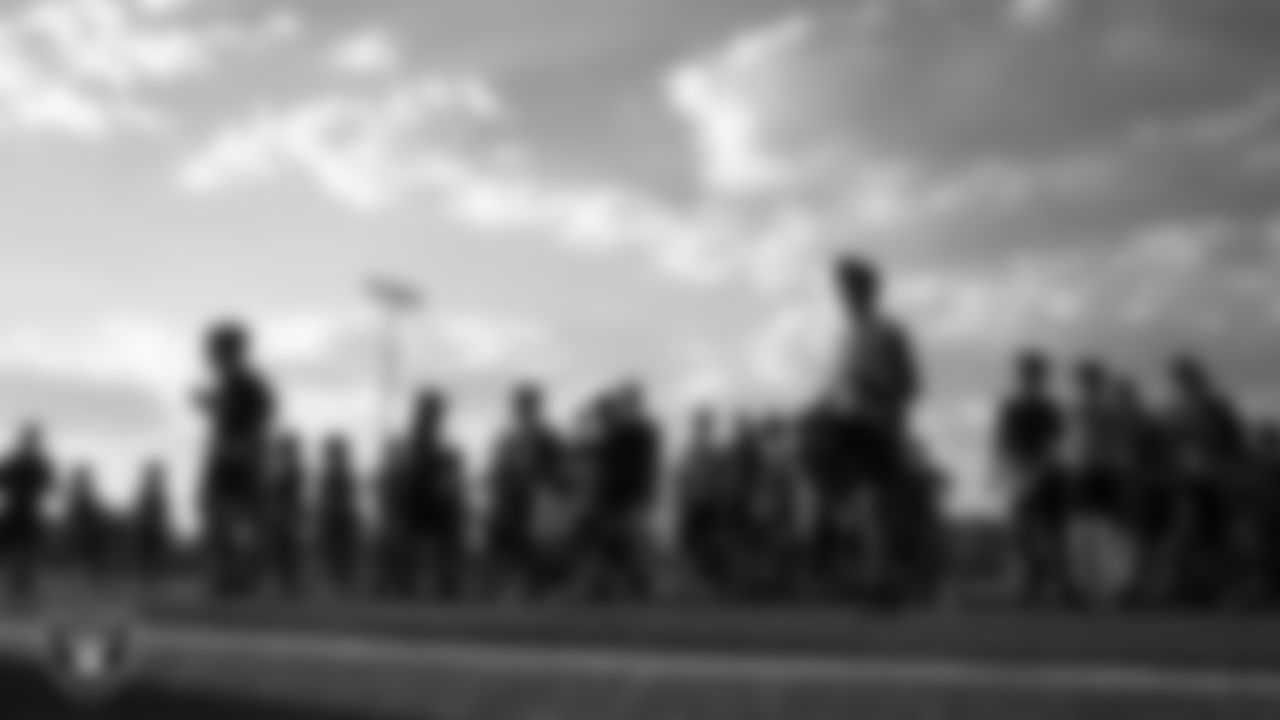 Athletes warm up during a season kick off camp for the Silver and Black Flag Football League at Teton Trails Park.