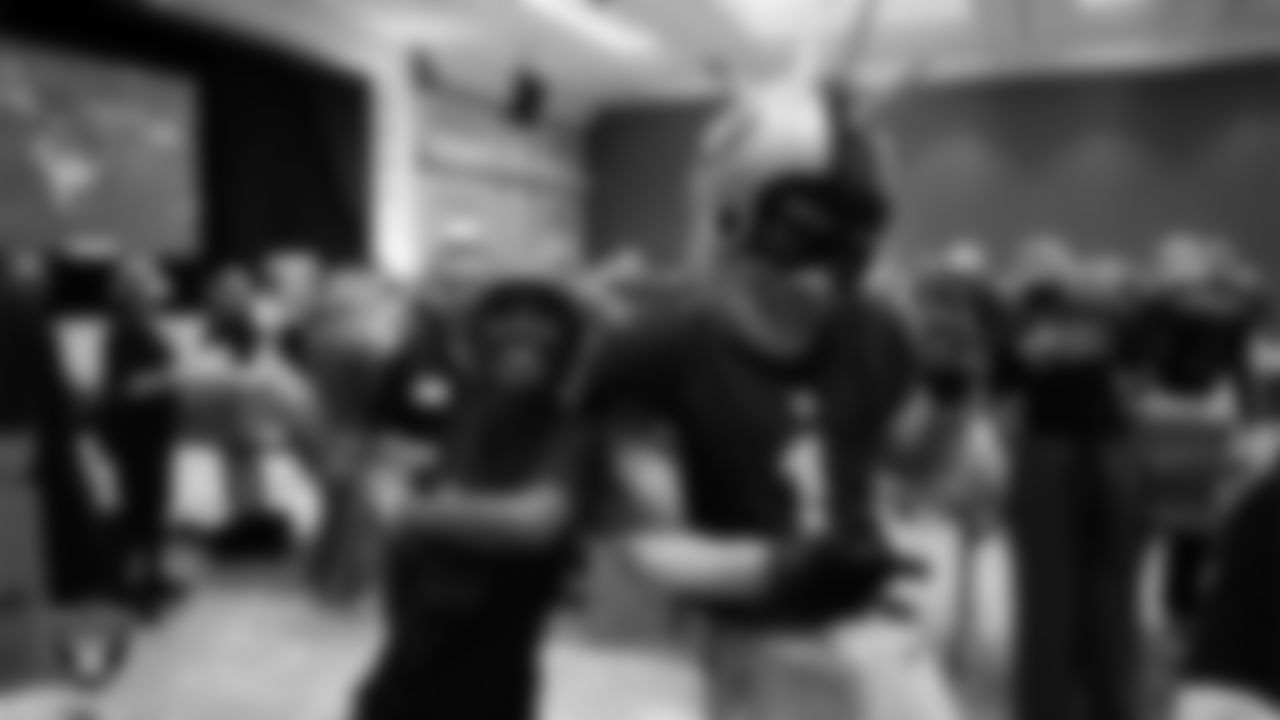 A volunteer and Raider Rusher during a Feed the Funnel Party at Wynn Las Vegas.