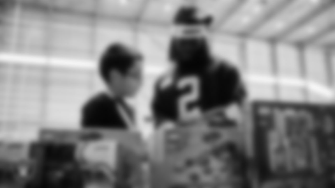 Las Vegas Raiders running back Ashton Jeanty (2) helps a student select toys during a Raiders Youth Holiday Party at Intermountain Health Performance Center.