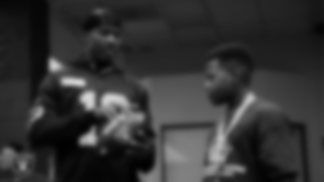 Las Vegas Raiders wide receiver Phillip Dorsett II (13) shows a member of the Boys and Girls Club how to throw a ball at the Lied Memorial Boys & Girls Clubs of Southern Nevada.