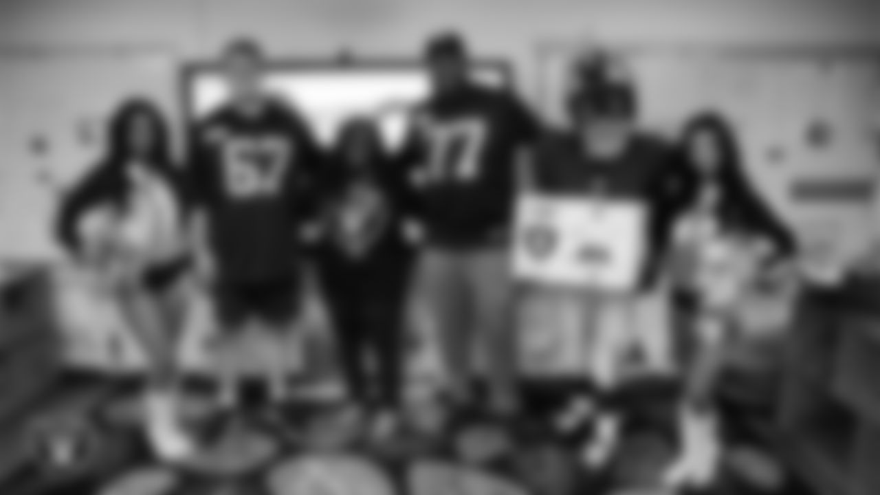 Raiderettes Cierra and Kylee, Raider Rusher and Las Vegas Raiders center Will Putnam (67) and tackle Thayer Munford Jr. (77) pose for a photo with a teacher while celebrating Teacher Appreciation Week at Matt Kelly Elementary School.