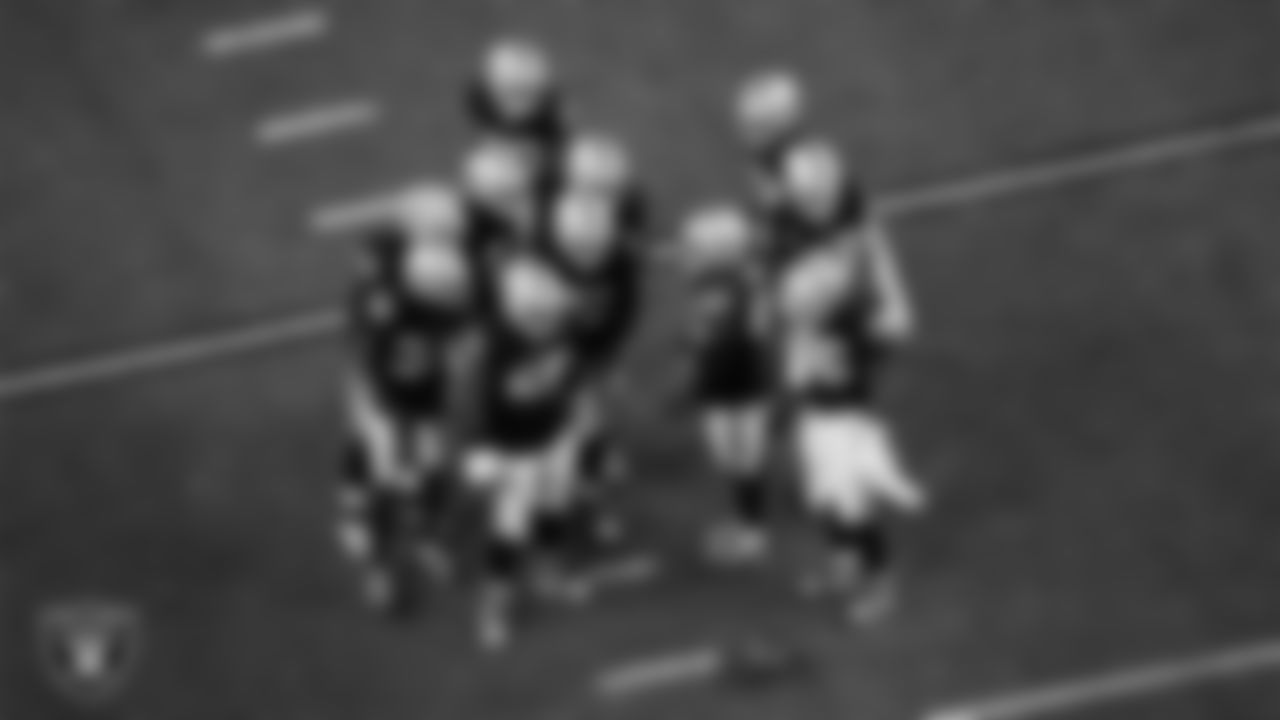 The Las Vegas Raiders defense huddles during the regular season home game against the Dallas Cowboys at Allegiant Stadium.