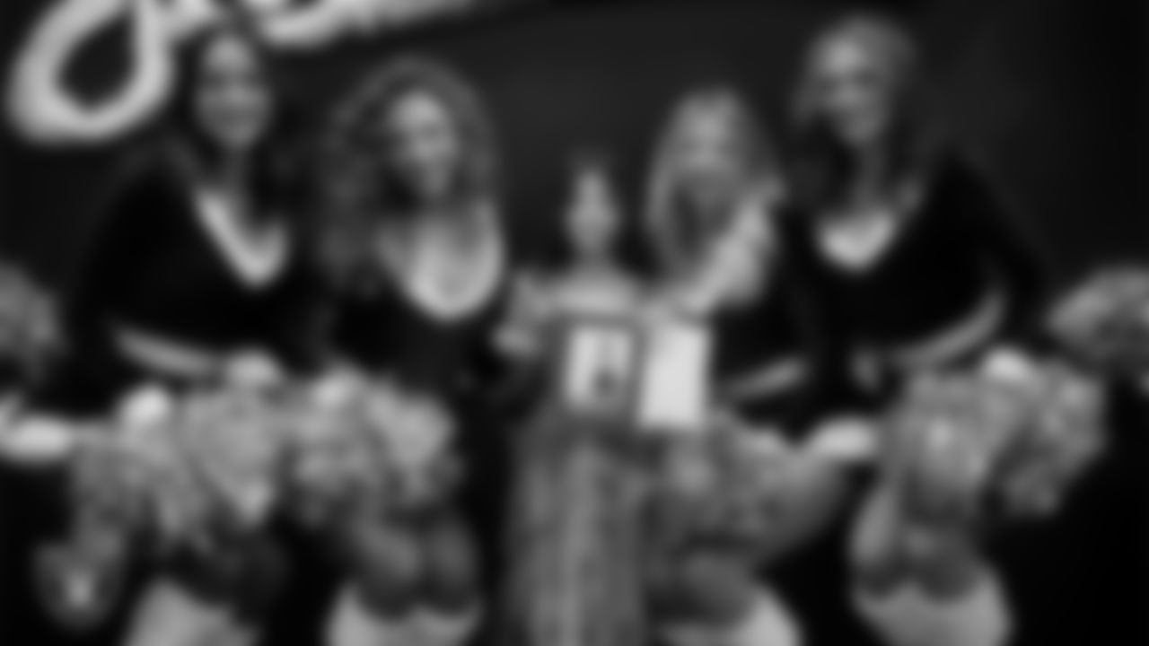 Raiderettes pose for a photo with a Junior Raiderette during the Junior Raiderettes Banquet at The Studio.