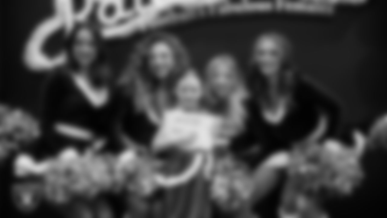 Raiderettes pose for a photo with a Junior Raiderette during the Junior Raiderettes Banquet at The Studio.