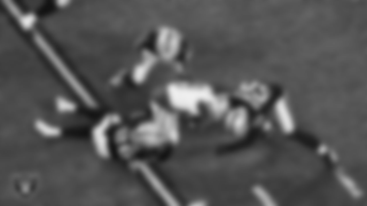 Las Vegas Raiders cornerback Darien Porter (26) and long snapper Jacob Bobenmoyer (50) make a tackle during the regular season home game against the Dallas Cowboys at Allegiant Stadium.