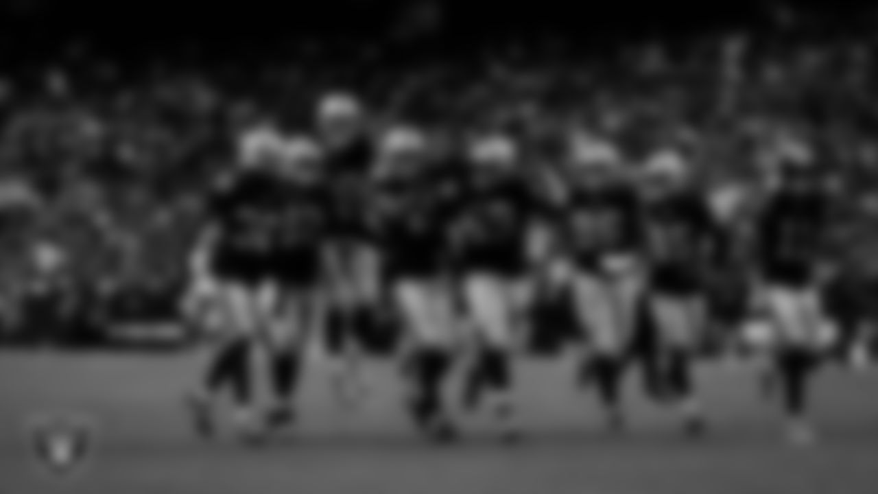 Las Vegas Raiders defensive end Charles Snowden (49) celebrates with teammates after making an interception during the regular season home game against the Cleveland Browns at Allegiant Stadium.